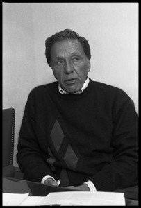 Eugene M. Isenberg: portrait, seated at a desk