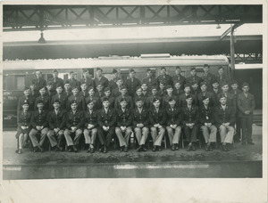 Group photograph of army medical unit in front of a transport train (Sidney Lipshires third from left, second row from top)