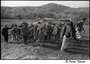Revelers carrying the maypole into the field, Packer Corners commune