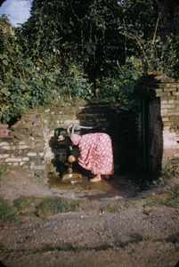 Woman washing at pump