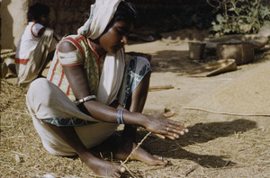 Young Ranchi woman twisting cane for baskets