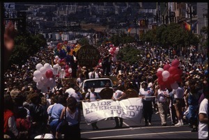 AIDS Emergency Fund marching in the San Francisco Pride Parade with float large in the rear: 'Every Penny Counts'