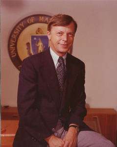 David C. Knapp sitting on edge of desk