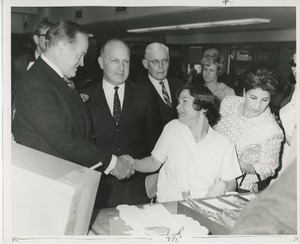 Bob Hope shaking hands with woman in workshop