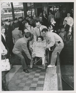 Woman in wheelchair boarding ship