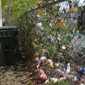 Toys in chain-link fence