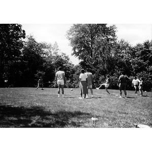 Inquilinos Boricuas en Acción employees playing soccer in a field during a staff outing.