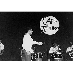 Los Muñequitos de Matanzas, a percussion, vocal, and dance ensemble from Cuba, on stage for a Café Teatro performance.