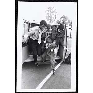 Five Boys' Club members getting off the car