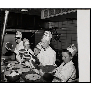 Members of the Tom Pappas Chefs' Club frost cakes