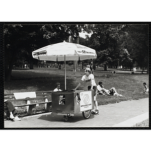 A teenage boy pushes his ice juice cart on Boston Common