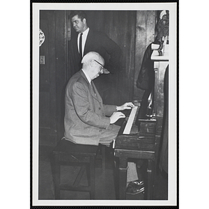 A man plays a piano at a Christmas event