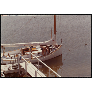 Children occupy the deck a docked sail boat