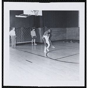 Two boys participate in a piggy back race in a gymnasium on Tom Sawyer Day