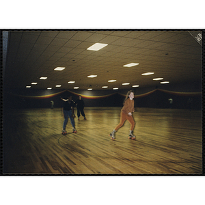 Children roller skate during a Tri-Club trip to Roller World