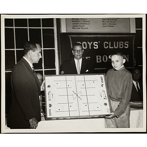 Gerald W. Blakeley, Jr., at left, and Boone Gross presenting an air hockey table to Michael Sarson at a Boys' Clubs of Boston Awards Night