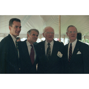 Three men pose with Harvey Krentzman at the dedication ceremony of Krentzman Quadrangle