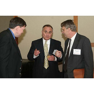 Three men stand together talking at the Training Future Innovators Entrepreneurs Panel