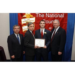 Joshua Seadia poses with his certificate and others at The National Council Dinner
