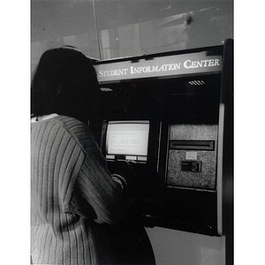 Ellis Pardede, a junior in the Business program, using the Ell Center Information Kiosk, Ell Center, 1st floor