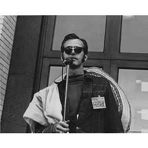 A man speaks into a microphone during the Mayor of Huntington Avenue campaign