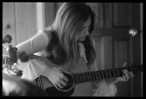Judy Collins playing guitar in Joni Mitchell's house in Laurel Canyon