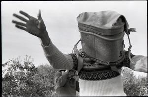 Commune member joking around with apple bucket on his head