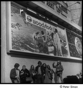 Group beneath the Woodstock movie billboard, Cheri theater