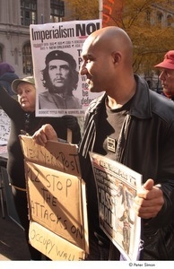 Occupy Wall Street: demonstrator holding copy of the New York Post and a sign that reads, 'New York Post, plz. stop the attacks on Occupy Wall St.'