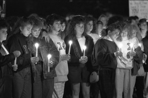 Sorority sisters lighting candles at a vigil