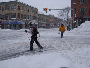 Man skiing across King Street near intersection with Main Street, Northampton, Mass.