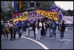 Marchers in the San Francisco Pride Parade carrying banner 'Lesbians of Color, Pacific Center, Berkeley'