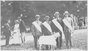 Four members of the class of 1905 standing in front of a goat