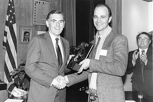 Mayor Raymond L. Flynn presenting book to unidentified man