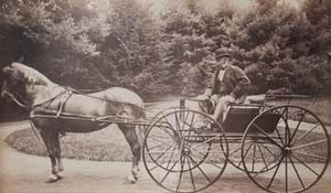 Robert W. Hooper in wagon pulled by horse