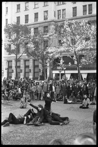 Street theater at the Vietnam Moratorium in New York: mimes in a pile after a gun fight