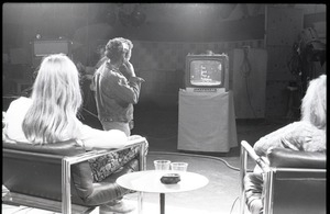 Commune members at the WGBY Catch 44 (public access television) interview: shot from the rear of Anne and Jim Baker on stage, looking at monitor showing title for "Free Spirit Press publishing"