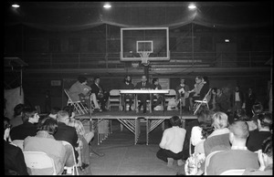 Mark Noffsinger (Associate Dean of Students, UMass Amherst) speaking at open meeting with school administration, Curry Hicks Cage, regarding protests against war in Vietnam