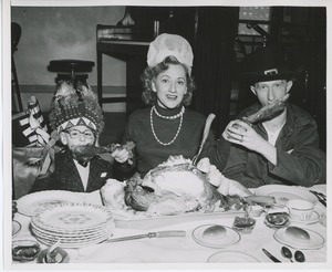 Connie Boswell eating turkey with two clients in costume