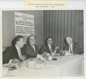 Men eating dinner during national employ the physically handicapped (neph) week