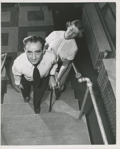 Physical therapist assisting man on stairs