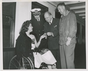 Young woman in wheelchair shown item