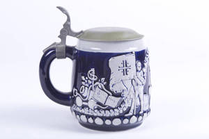 Stoneware stein with 4F shield and Turners on dark blue background