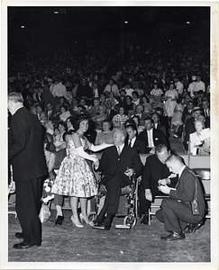 Mayor John F. Collins shaking hands with unidentified woman