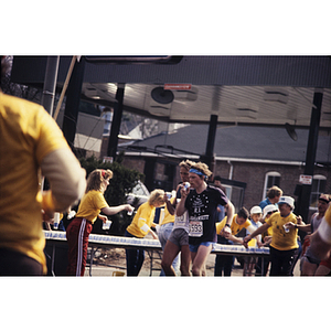 View of YMCA staff in yellow shirts and runners during Boston Athletic Association (BAA) marathon