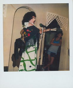 A Photograph of Billie Loba Singing Wearing a Shawl