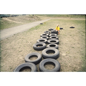 Child playing on tires on a playground