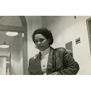Female standing in hallway; she is participating in a program at La Alianza Hispana, Boston.