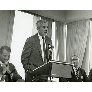 An unidentified man speaks at the podium during a Boys' Club meeting