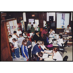 Parents and children signing up for activities during an open house